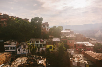 High angle view of buildings in town against sky