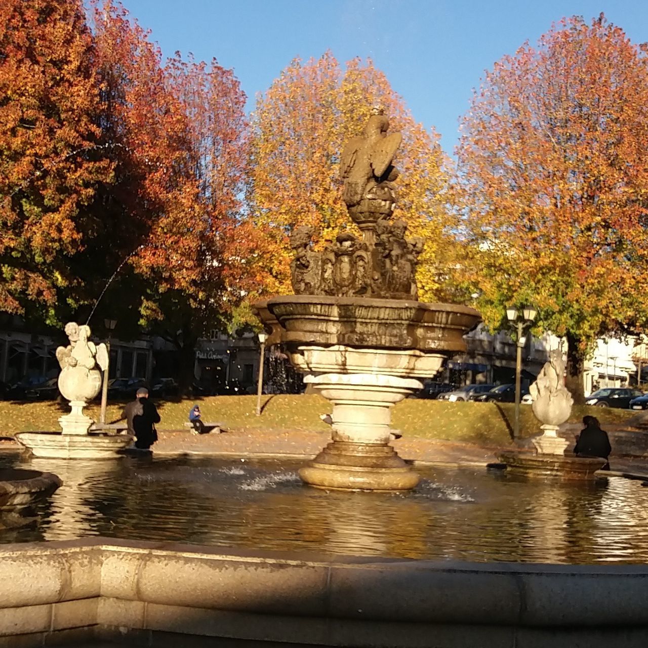 STATUE BY FOUNTAIN AGAINST TREES