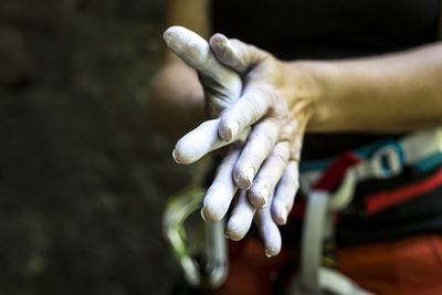 Close-up of woman rubbing hands with chalk