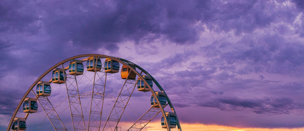 Low angle view of ferris wheel against sky