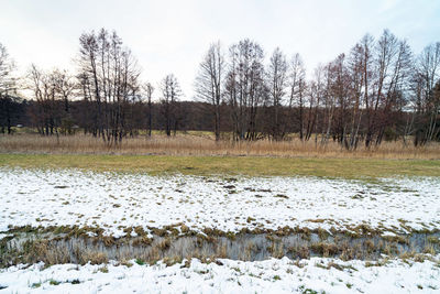 Scenic view of frozen lake against sky during winter