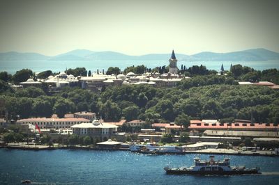 Boats in river with buildings in background