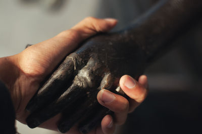 Close-up of hand holding statue