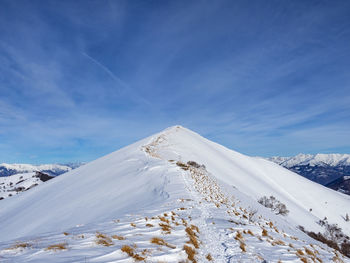 Snow covered mountain against blue sky