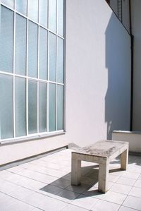 High angle view of table on floor against wall of white building