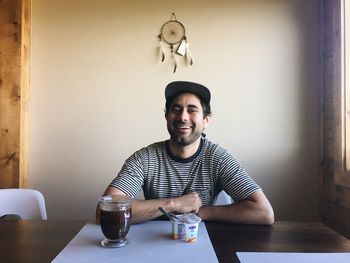 Portrait of young man sitting at table