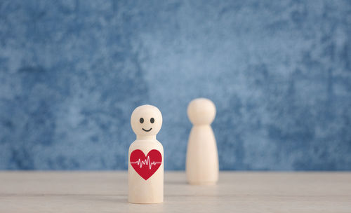 Close-up of toy on table against wall