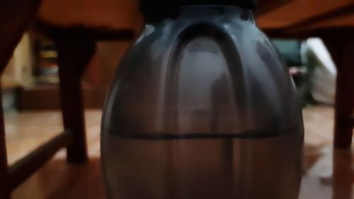 Close-up of glass bottle on table
