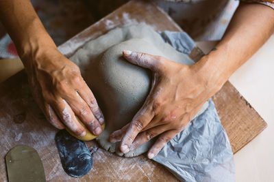 Cropped hands of person preparing food on table