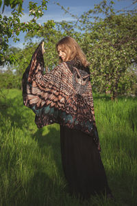 Lady from behind with owl wings shawl scenic photography