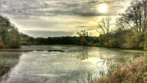 Scenic view of lake against cloudy sky