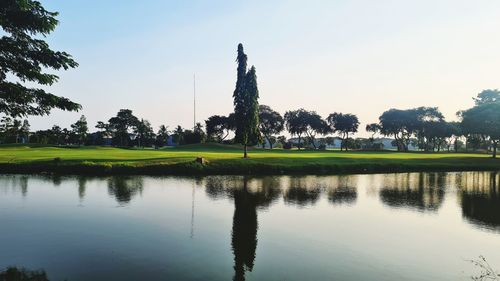 Reflection of trees on lake against sky