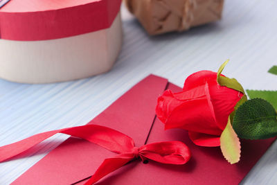 Close-up of red rose on table