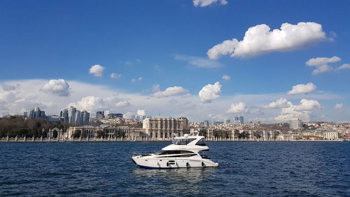 Ship in sea against buildings in city