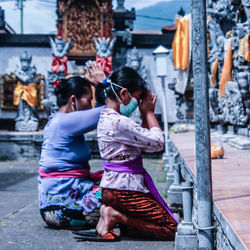 Rear view of women walking in temple