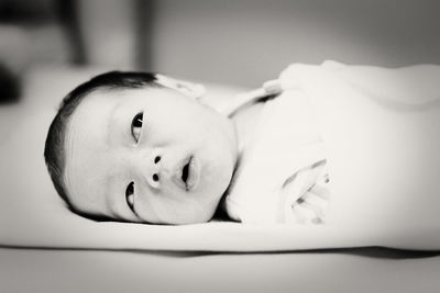 Close-up of newborn baby lying down