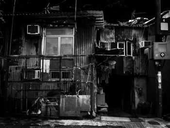 Abandoned house by building in city