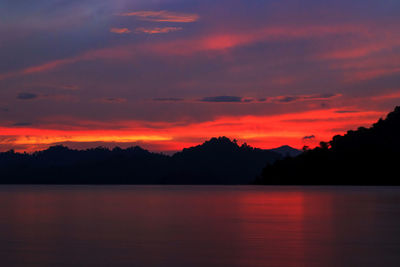 Scenic view of lake against romantic sky at sunset