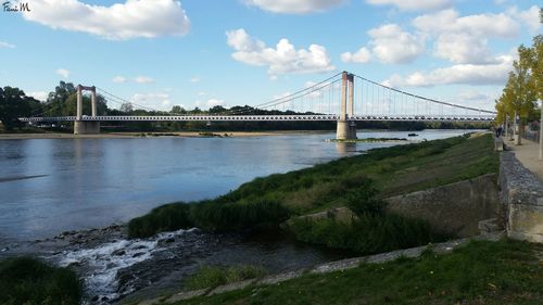 Golden gate bridge over river against sky in city