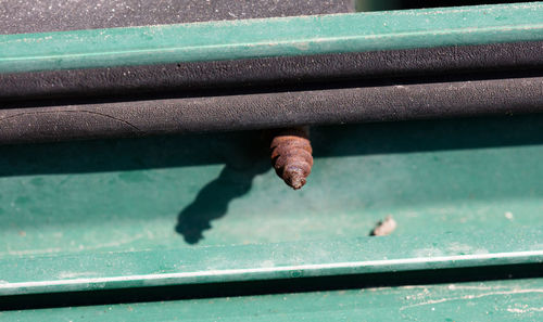 High angle view of rusty screw on metal