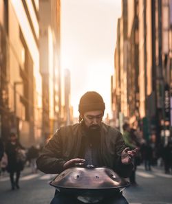 Man with umbrella on street in city