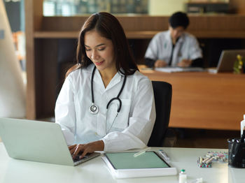 Doctor using laptop at hospital