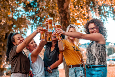 Happy young woman with arms raised