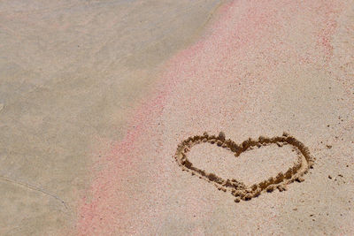 High angle view of heart shape on sand