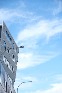 Low angle view of building against cloudy sky
