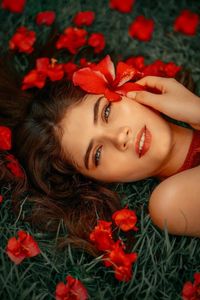 Portrait of woman with red flowers