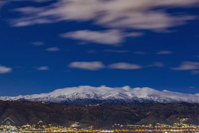 Scenic view of snowcapped mountains against sky at night