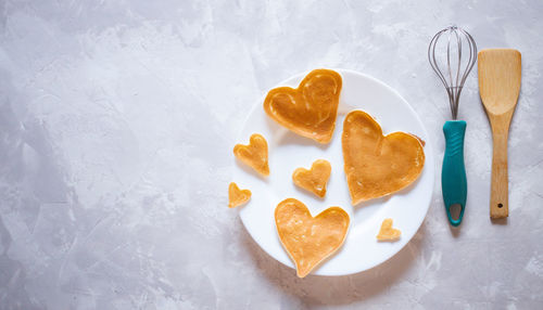 Creative breakfast for valentine's day. heart shaped pancakes with strawberries on a plate