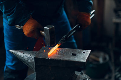 Midsection of man working at workshop