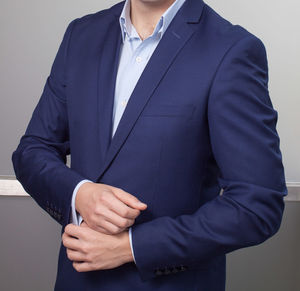 Midsection of man standing against white background