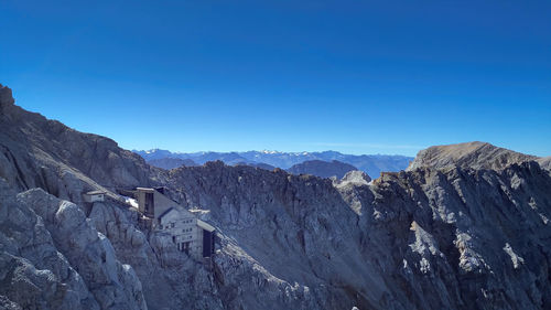 Scenic view of mountains against clear blue sky