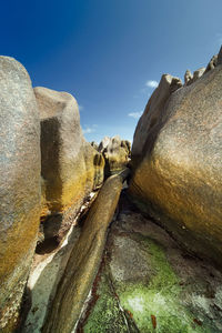 Low angle view of rock formation against sky