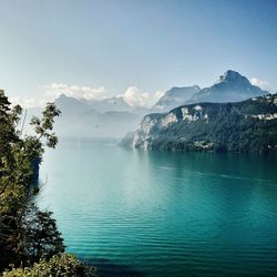 Scenic view of lake and mountains against sky