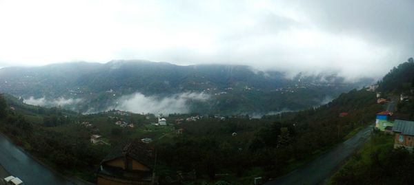 Scenic view of mountains against cloudy sky