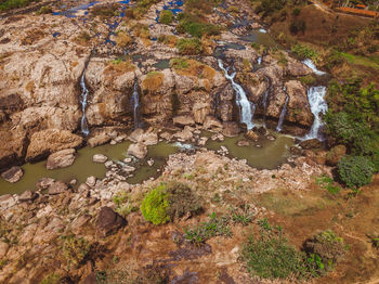 High angle view of water flowing through rocks