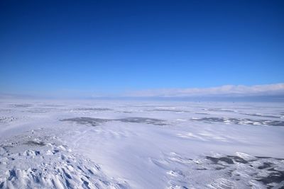 Scenic view of sea against blue sky during winter