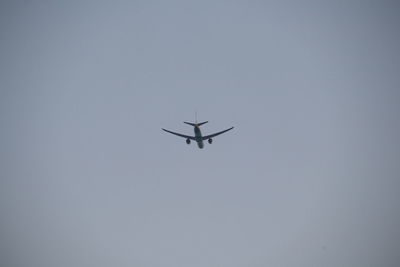 Low angle view of airplane against clear sky