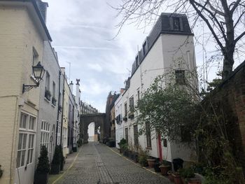 Street amidst buildings against sky