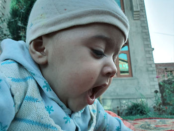 Close-up portrait of cute boy looking away