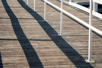 Shadow of railing on footpath