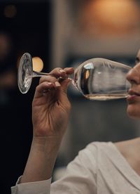 Cropped image of woman drinking wine