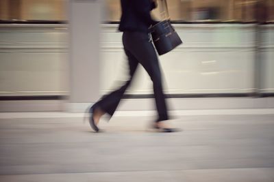 Low section of woman walking in bus