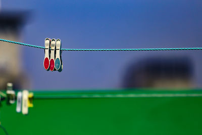 Close-up of hanging against sky