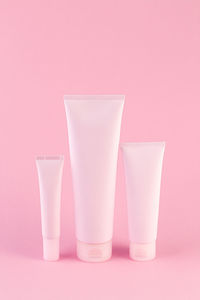 Close-up of drink in glass against pink background