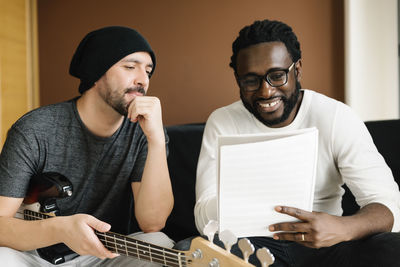 Music composers discussing in studio