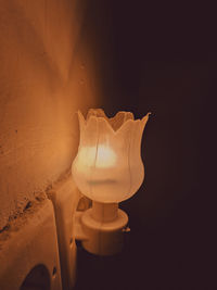 Close-up of illuminated lamp on wall